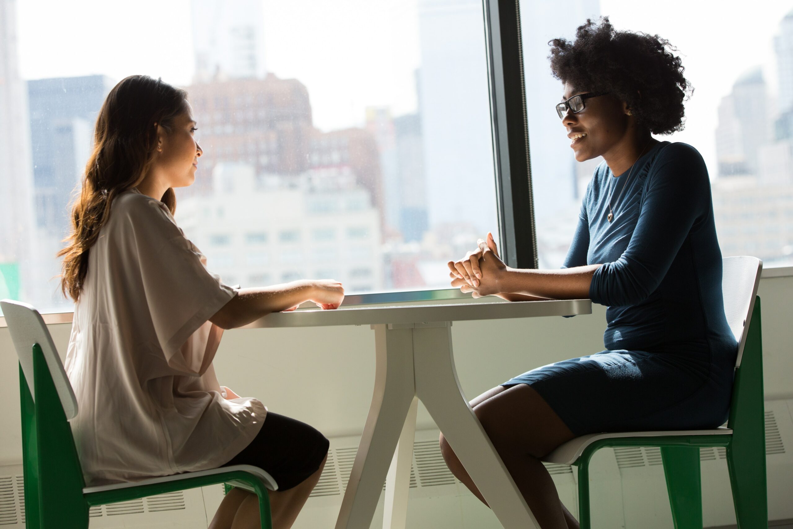 Two women sitting at a table having a meeting