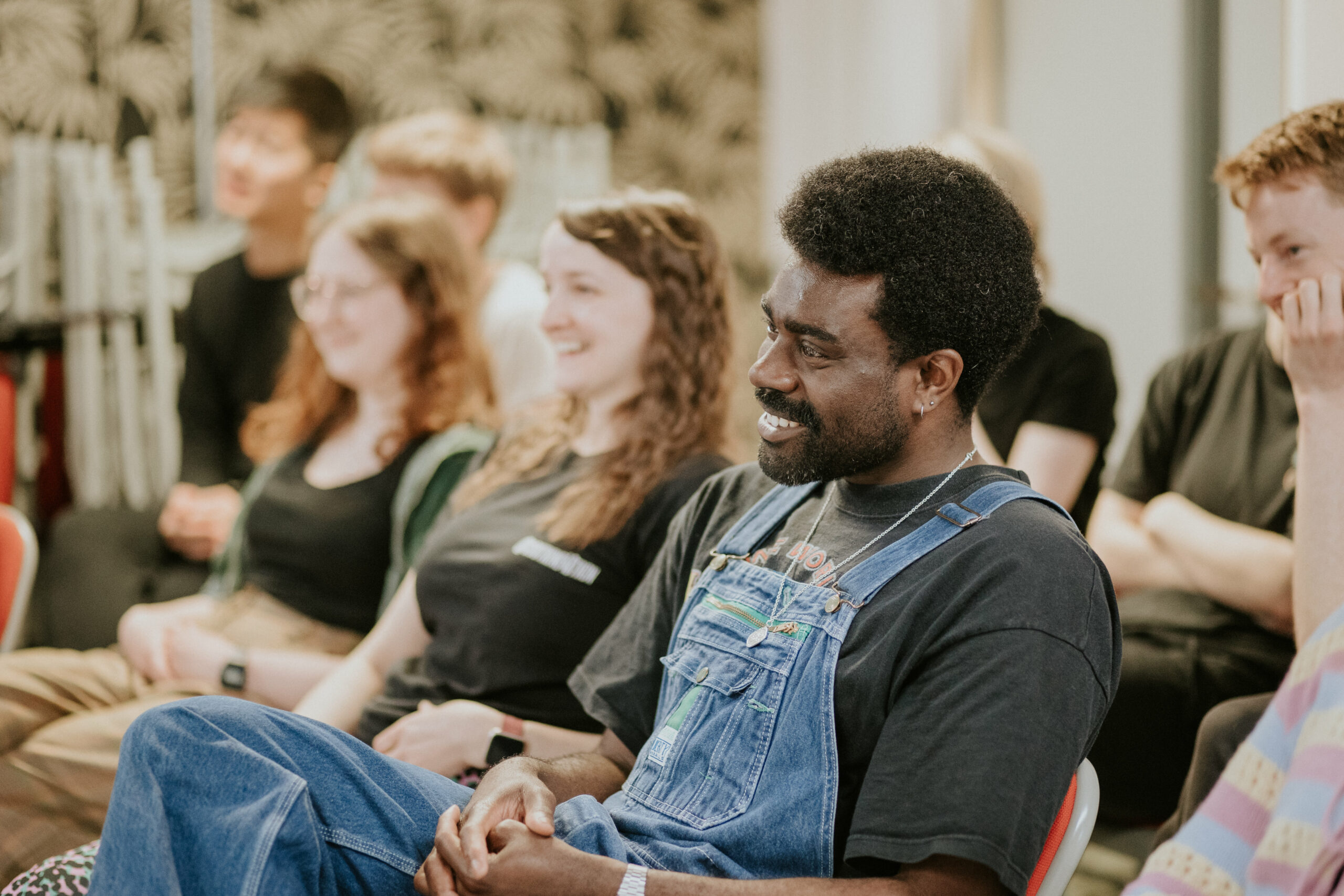 Actors sitting and smiling at a Spotlight workshop