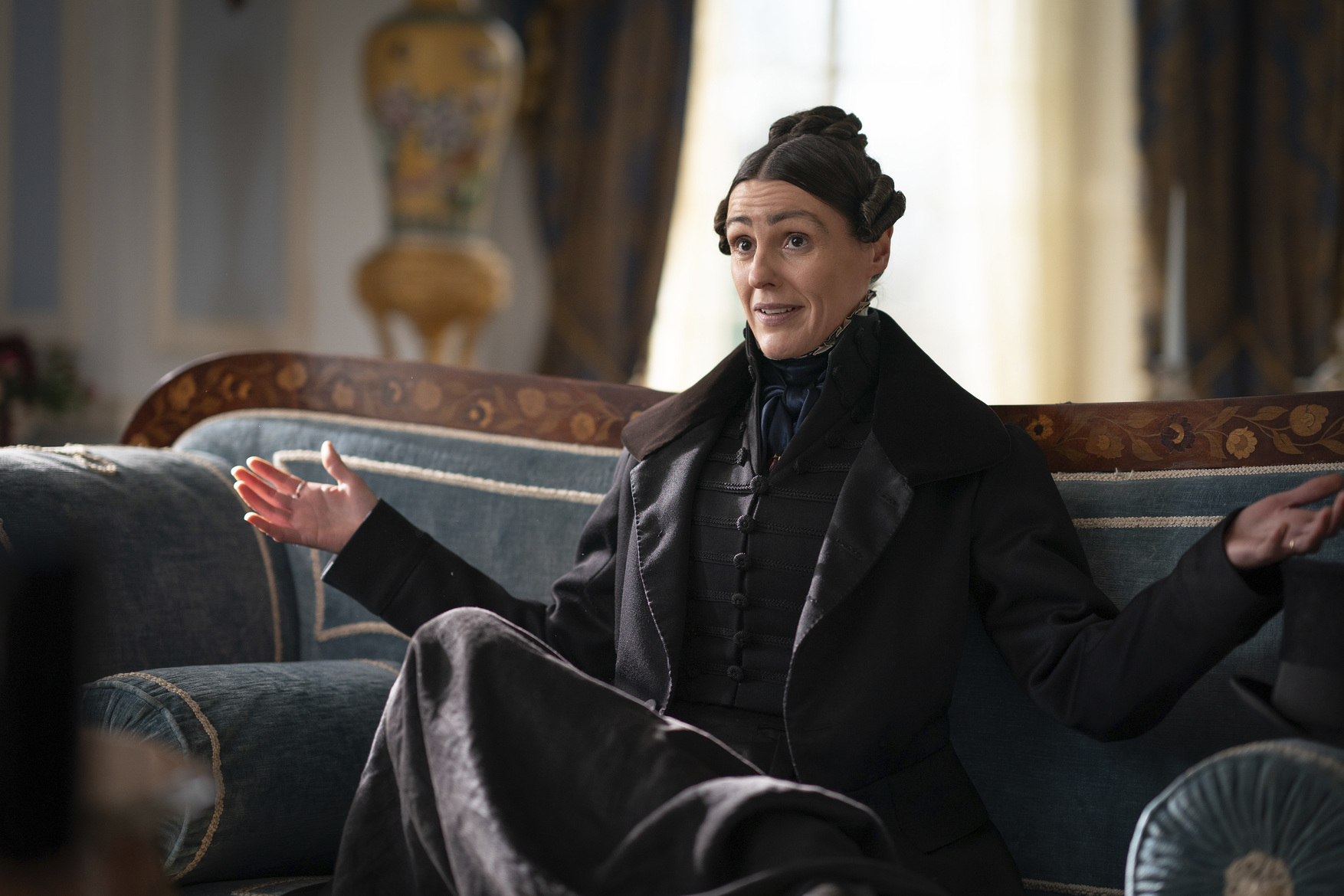 Suranne Jones as Anne Lister sitting on a sofa in 'Gentleman Jack'