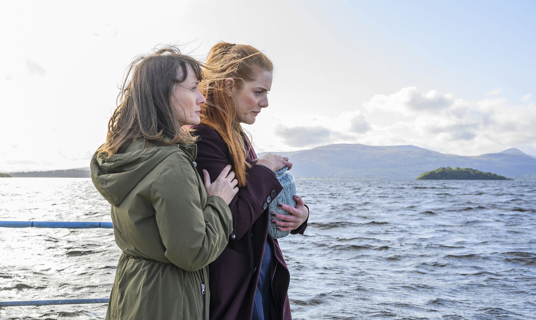 Eve Christie and Amber Murdoch standing by the water in 'River City'