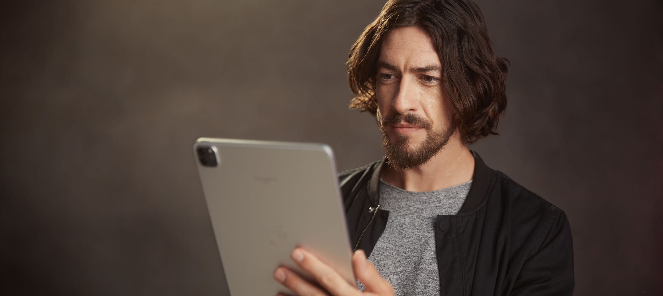 An actor looks at the Spotlight app on a tablet device.