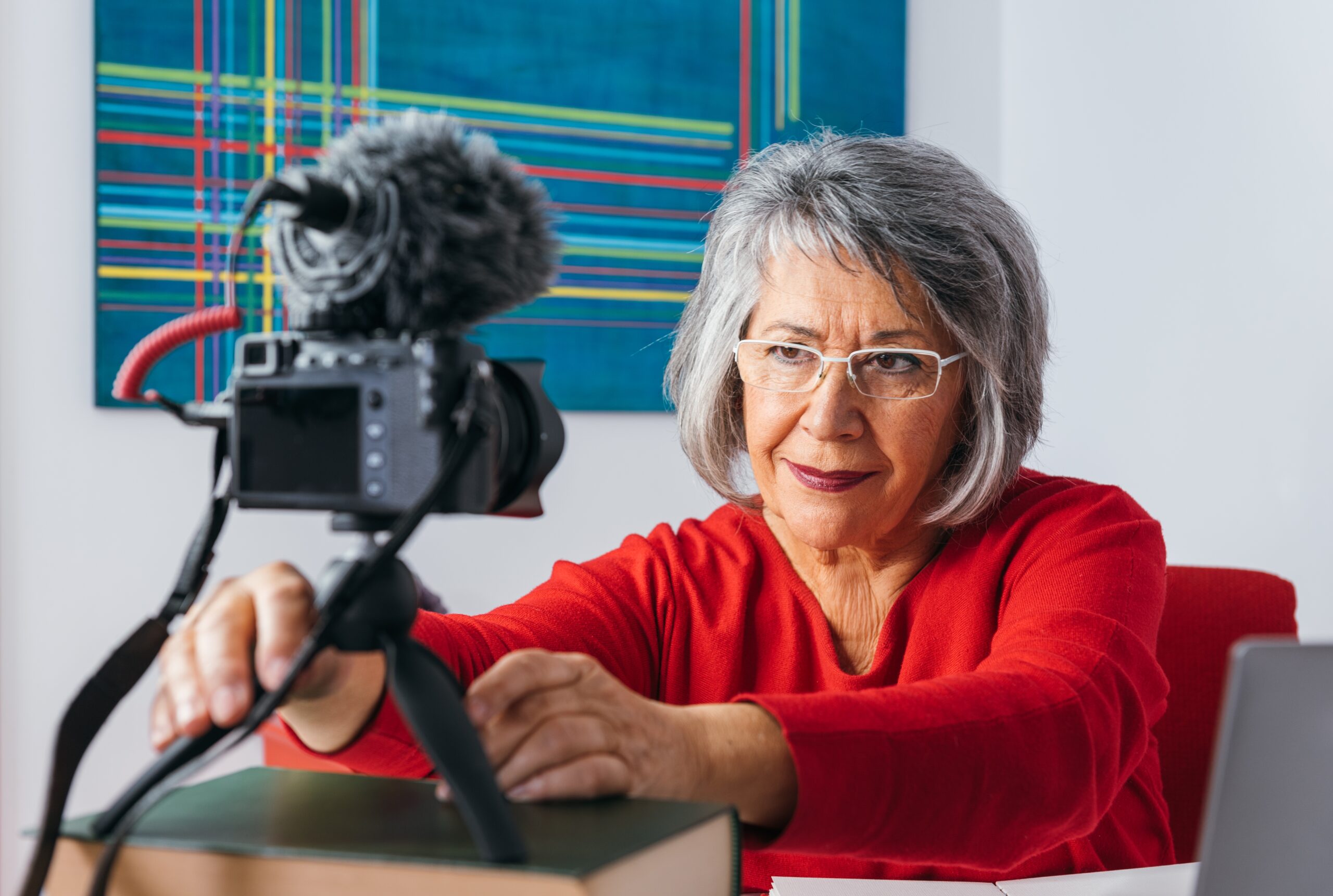 Senior actress setting up a camera for a self-tape