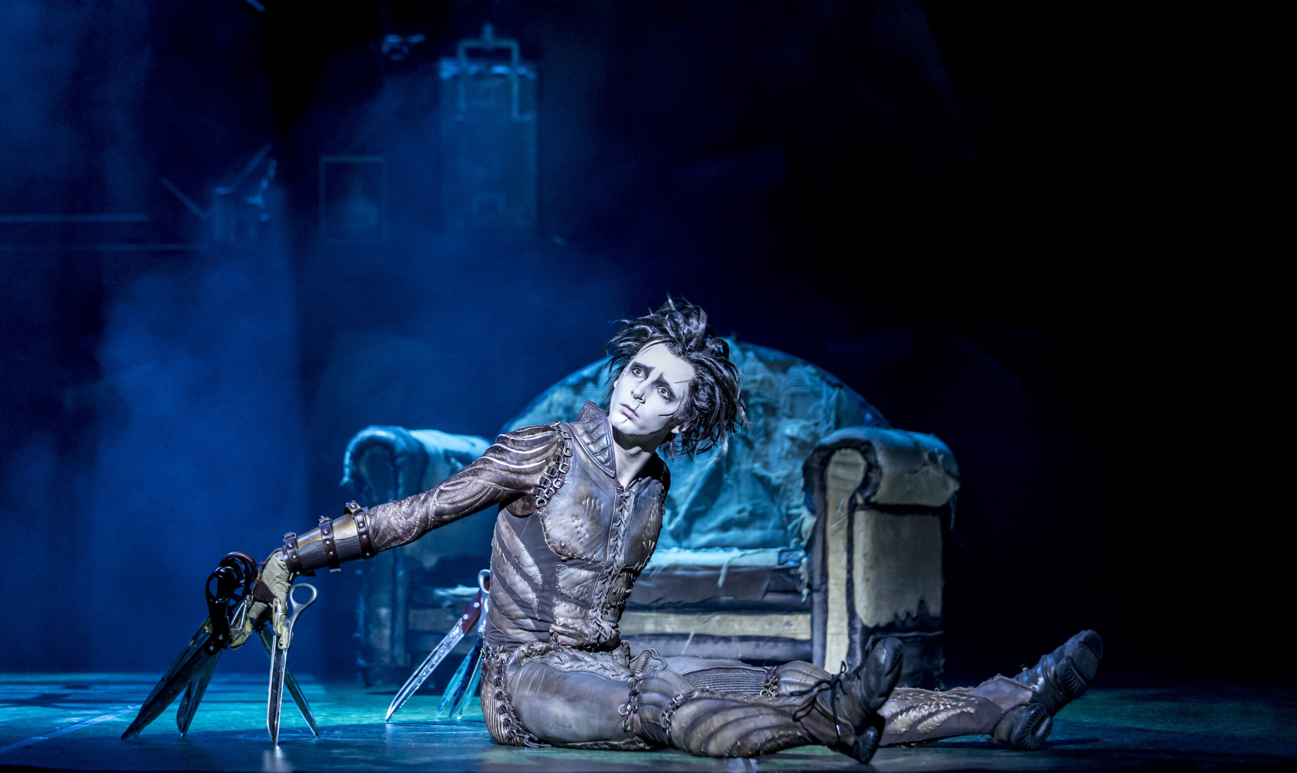 Edward Scissorhands sitting on stage in Matthew Bourne's theatre show