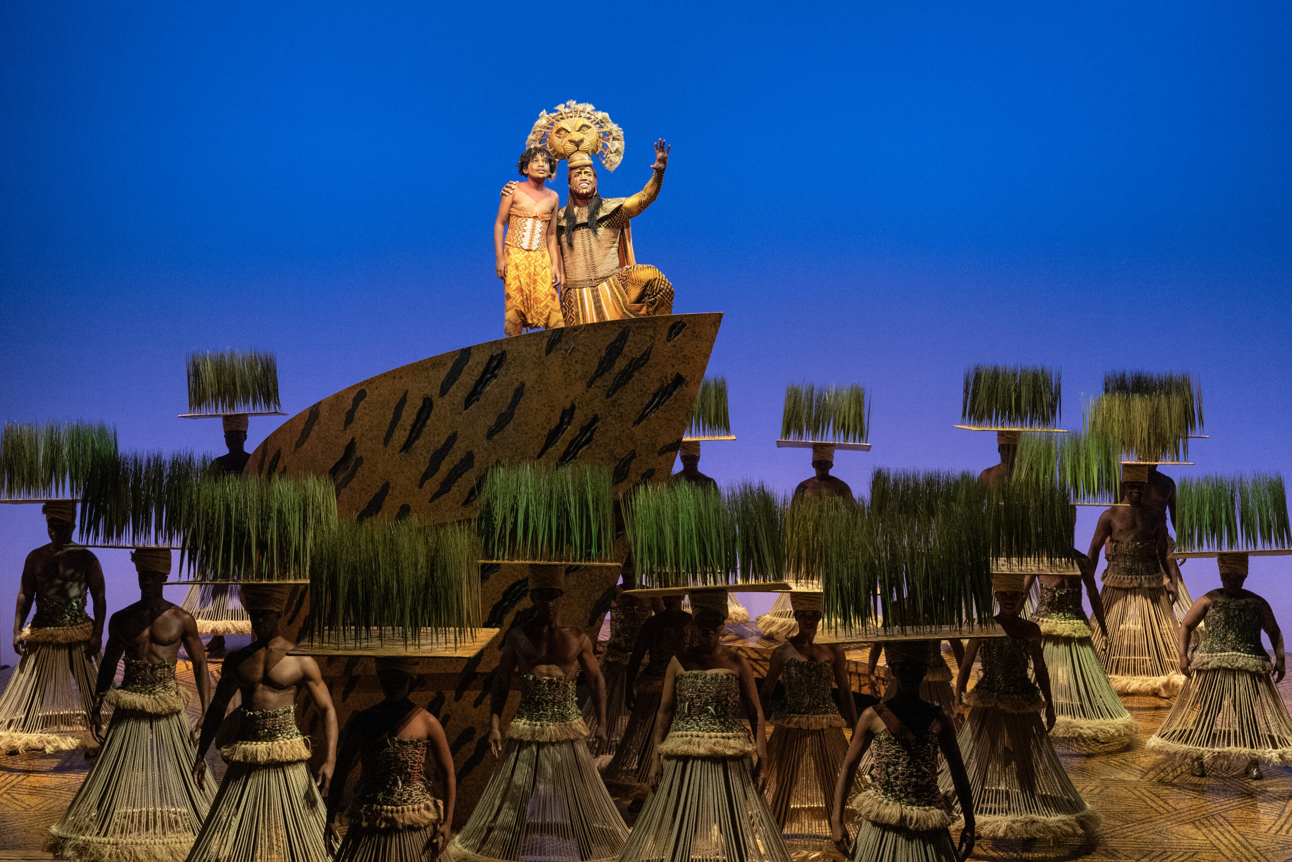 Simba and Mufasa standing on Pride Rock in Disney's The Lion King show